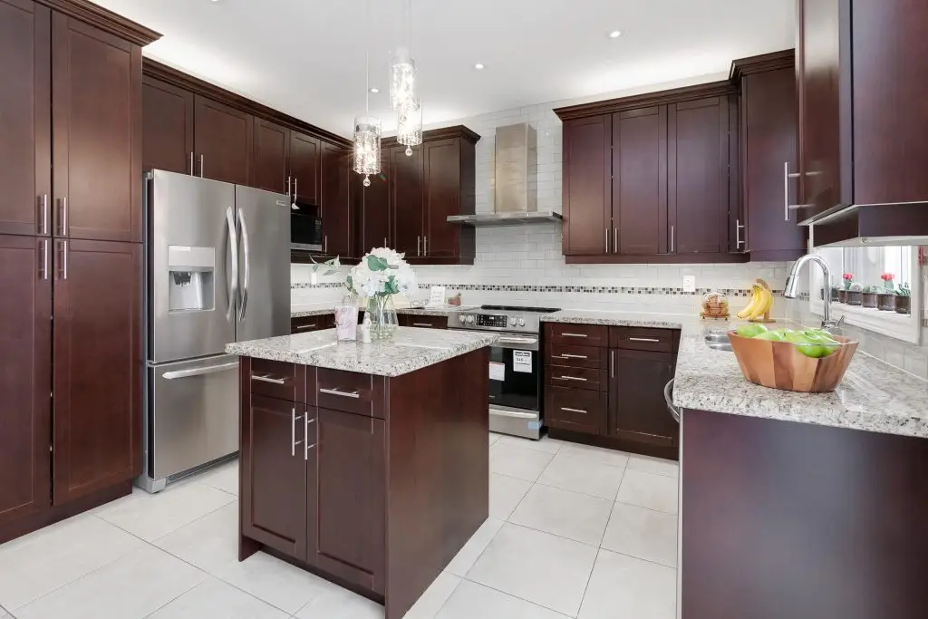 Kitchen with warm wood cabinetry in a Vaughan contemporary home by Euphoric Design Studio, interior designer in Vaughan